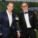 Neil Poulter with his son Will Poulter at a formal event.
