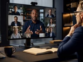A professional businessman participating in a structured virtual team meeting on a desktop monitor